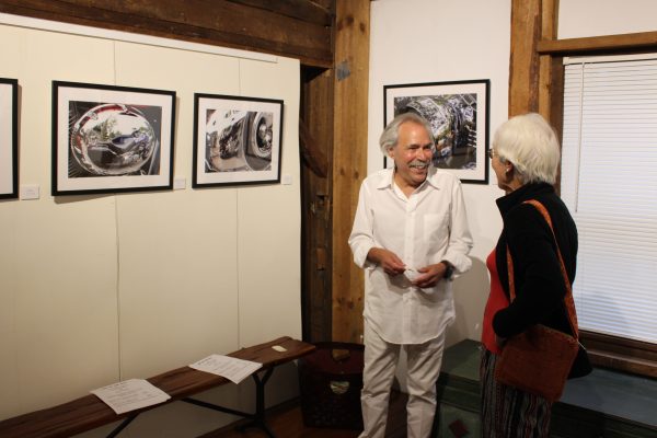 Gary Halby chats with a gallery visitor